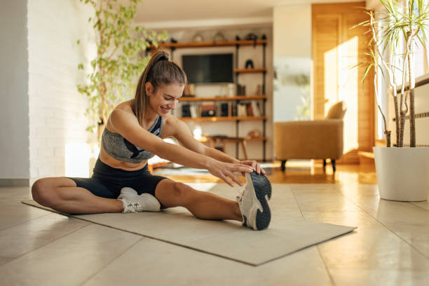 Smiling caucasian woman, exercising early in the morning, at home